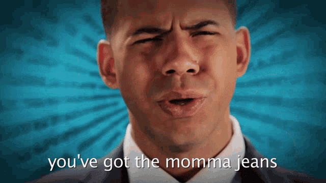 a man in a suit and tie is saying " you 've got the momma jeans "