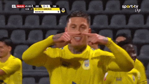 a soccer player in a yellow jersey is making a funny face