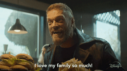 a man eating a hamburger with the words i love my family so much on the bottom