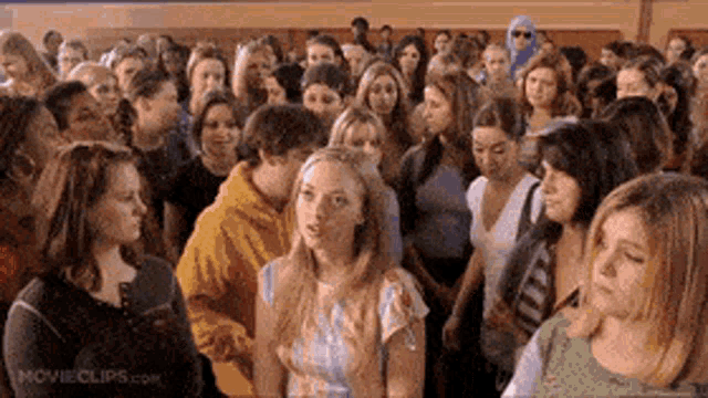 a large group of people are gathered in a room with movieclips.com on the bottom