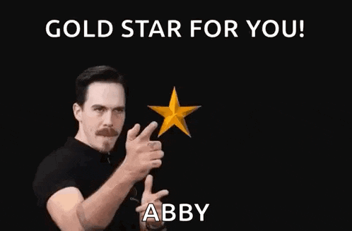a man is pointing at two gold stars with his fingers .