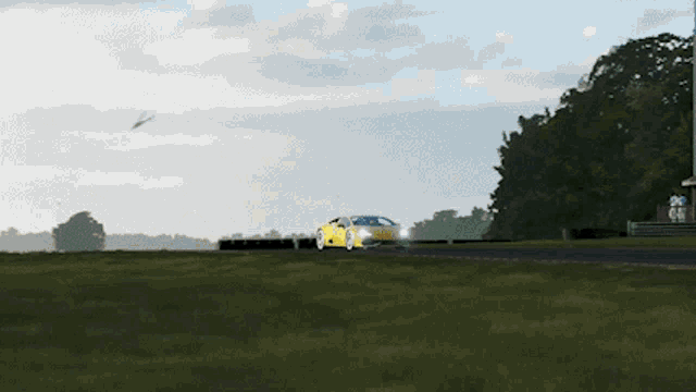 a yellow lamborghini is driving on a race track