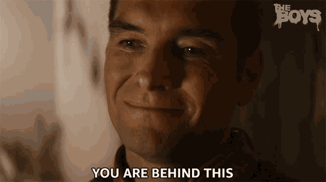a man is smiling with the words you are behind this below him
