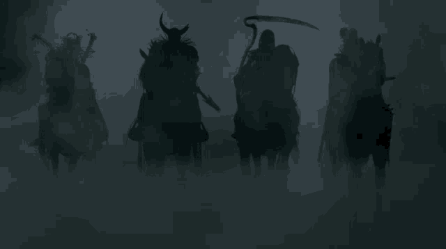 a group of riders are silhouetted in the fog