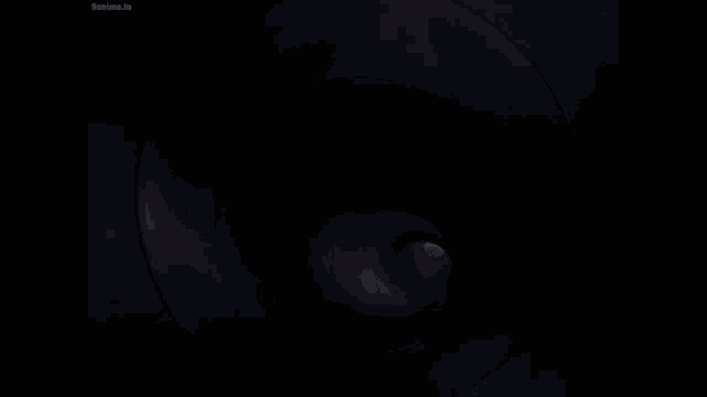 a close up of a cartoon character 's face with a black background and a white star in his mouth