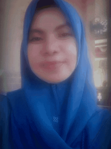 a woman wearing a blue hijab with the letter x on her neck