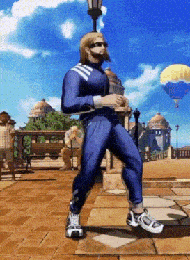 a man in a blue outfit is dancing in front of a parachute