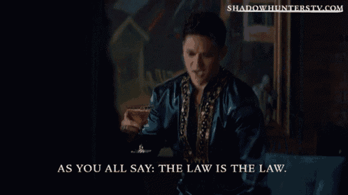 a man holding a martini with the words as you all say the law is the law on the bottom