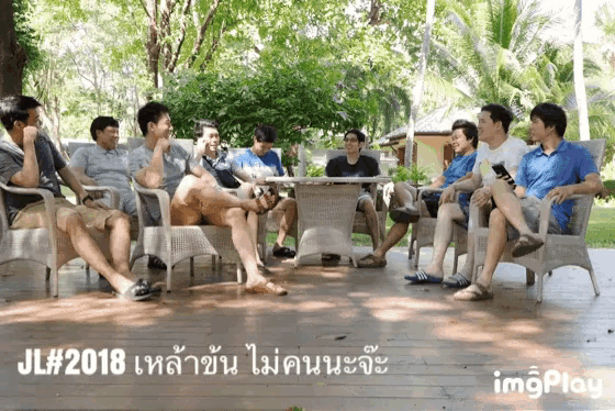 a group of men are sitting around a table with jl # 2018 in the corner