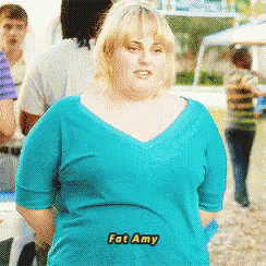 a woman in a blue shirt with fat amy written on the front