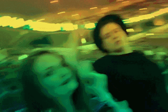 a blurry picture of a man and a woman dancing in a dark room