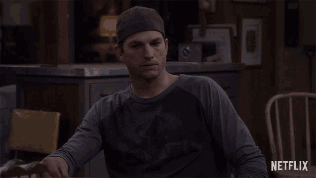 a man wearing a hat and a netflix shirt