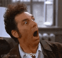 a man is making a surprised face with his mouth open and the word wow on his face .
