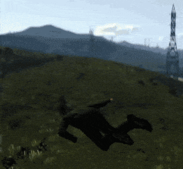 a man in a black suit is doing a handstand in the air