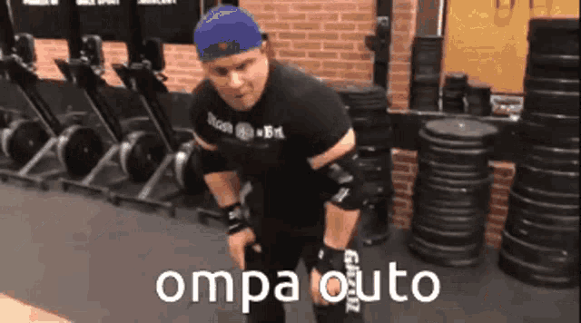 a man is standing in a gym with the words oma otuto on the bottom