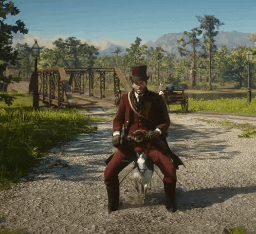 a man in a top hat is riding a horse on a gravel road