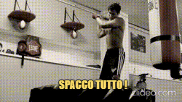 a man in a boxing gym with the words spacco tutto on the bottom