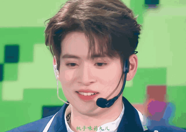 a man wearing a microphone with chinese writing on the bottom