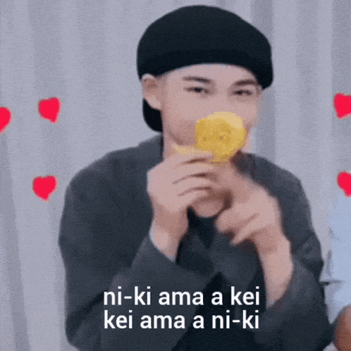 a man wearing a beret is eating a lemon with a caption that says ni-ki ama a kei