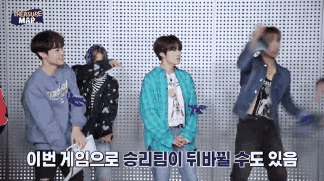 a group of young men are dancing in front of a wall with treasure map written on it
