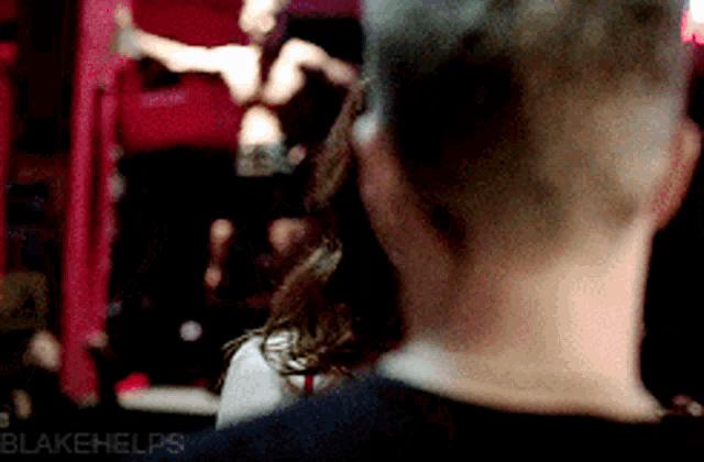 a blurry picture of a man and a woman with blakehelps written on the bottom right