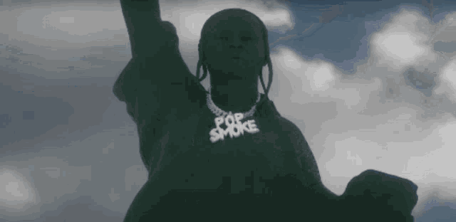 a statue of a man with a pop smoke necklace around his neck