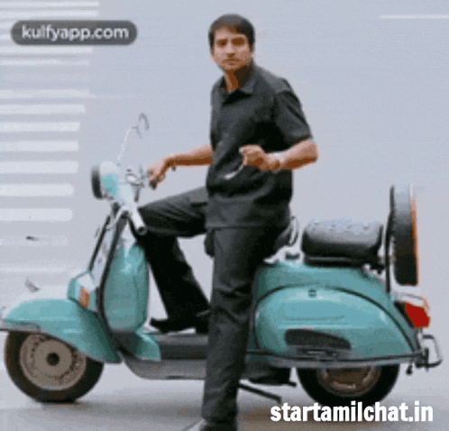 a man is standing next to a blue scooter .