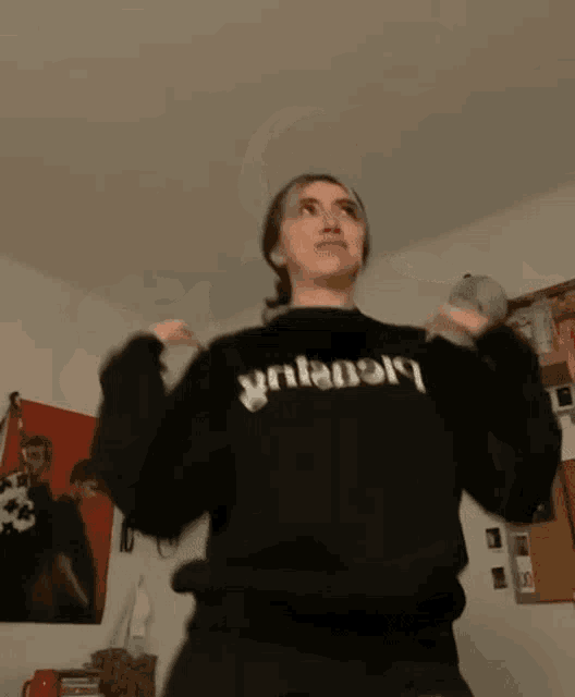a girl wearing a black sweatshirt with the word nissy on it