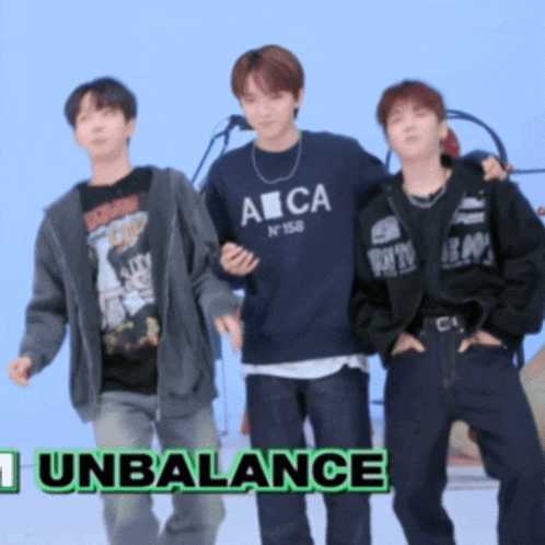 a group of young men standing next to each other with the words " unbalance " in green