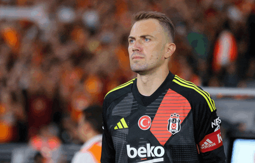 a man wearing a black and red beko jersey