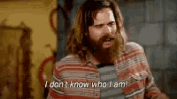 a man with a beard is standing in a room and says `` i don 't know who i am ! ''