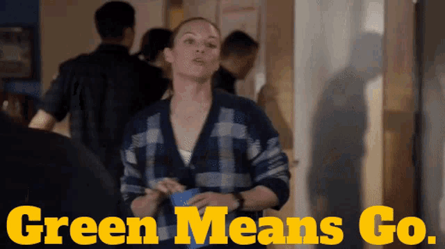 a woman stands in a hallway with the words green means go