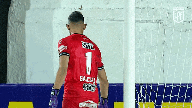 a soccer player wearing a red jersey with the number 1 on the back