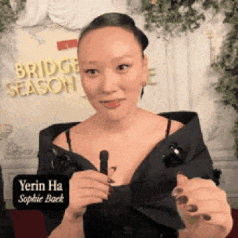 a woman with a sign that says bridge season