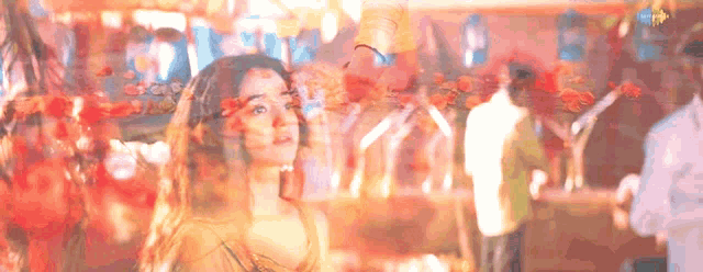 a woman with flowers in her hair is standing in a crowd of people