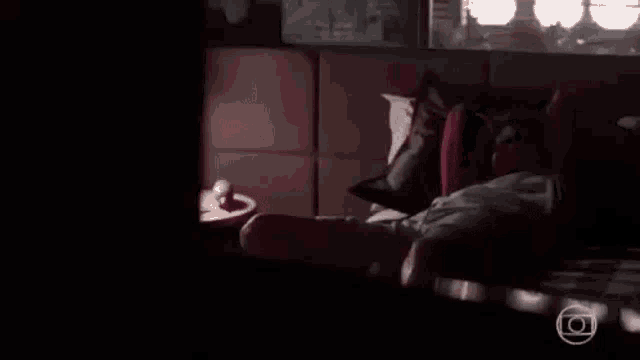 a man is laying on a bed with his head on another man 's lap .