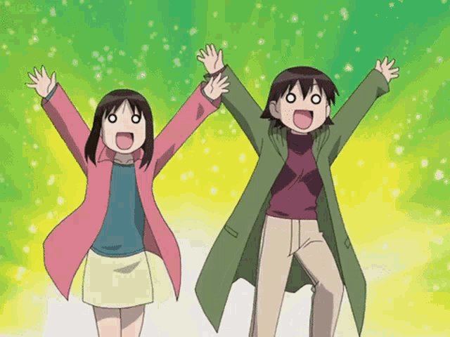 a boy and a girl are standing with their hands in the air