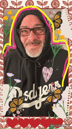 a man wearing a dodgers hoodie is surrounded by butterflies
