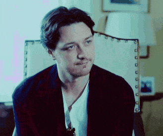a man is sitting in a chair looking at something