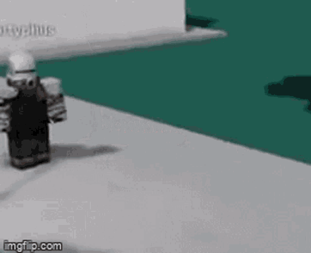 a robot is standing on a white surface in front of a green background .
