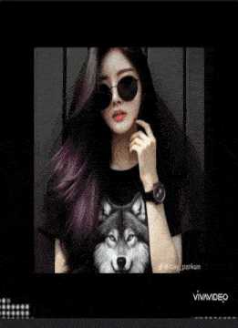 a woman wearing sunglasses and a wolf t-shirt