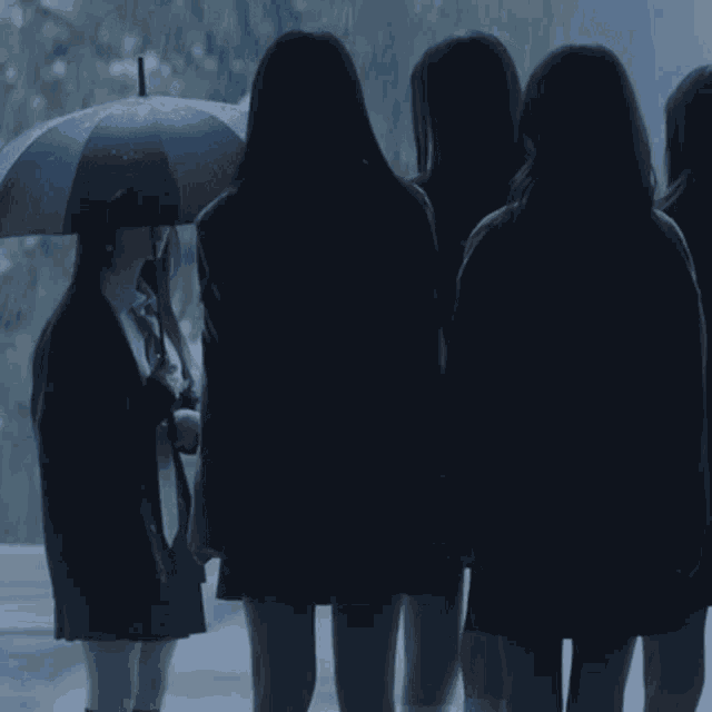 a girl holding an umbrella in the rain