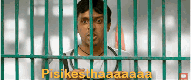 a man behind bars with the words pisikesthaaaa written on the screen