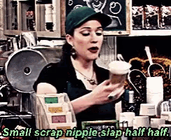 a woman in a green hat is holding a cup of coffee and saying small scrap nipple slap half half .