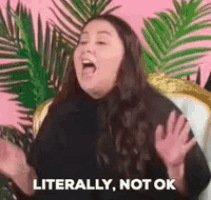 a woman is sitting in a chair and making a funny face .