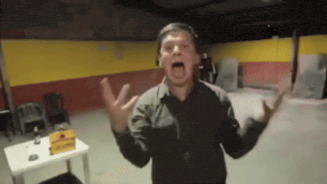 a man in a black shirt is screaming in a room