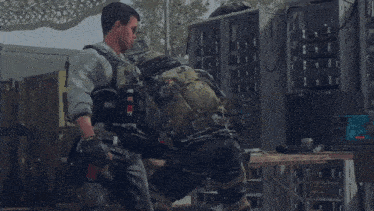 a group of soldiers are standing around a table and one of them is wearing a vest that says t24b