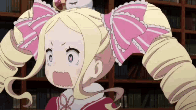 a girl with blonde hair and a pink bow in her hair is making a surprised face .