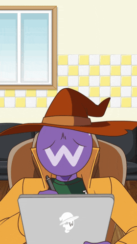 a cartoon character wearing a witch hat is sitting at a desk with a laptop