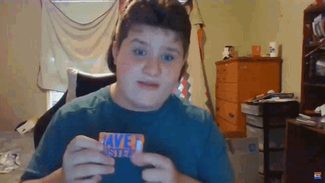 a boy in a blue shirt holds a card that says save foster